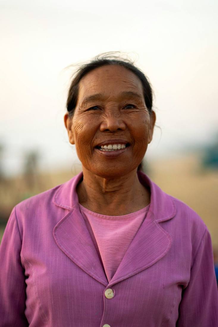 A smiling grandmother in a pink jacket